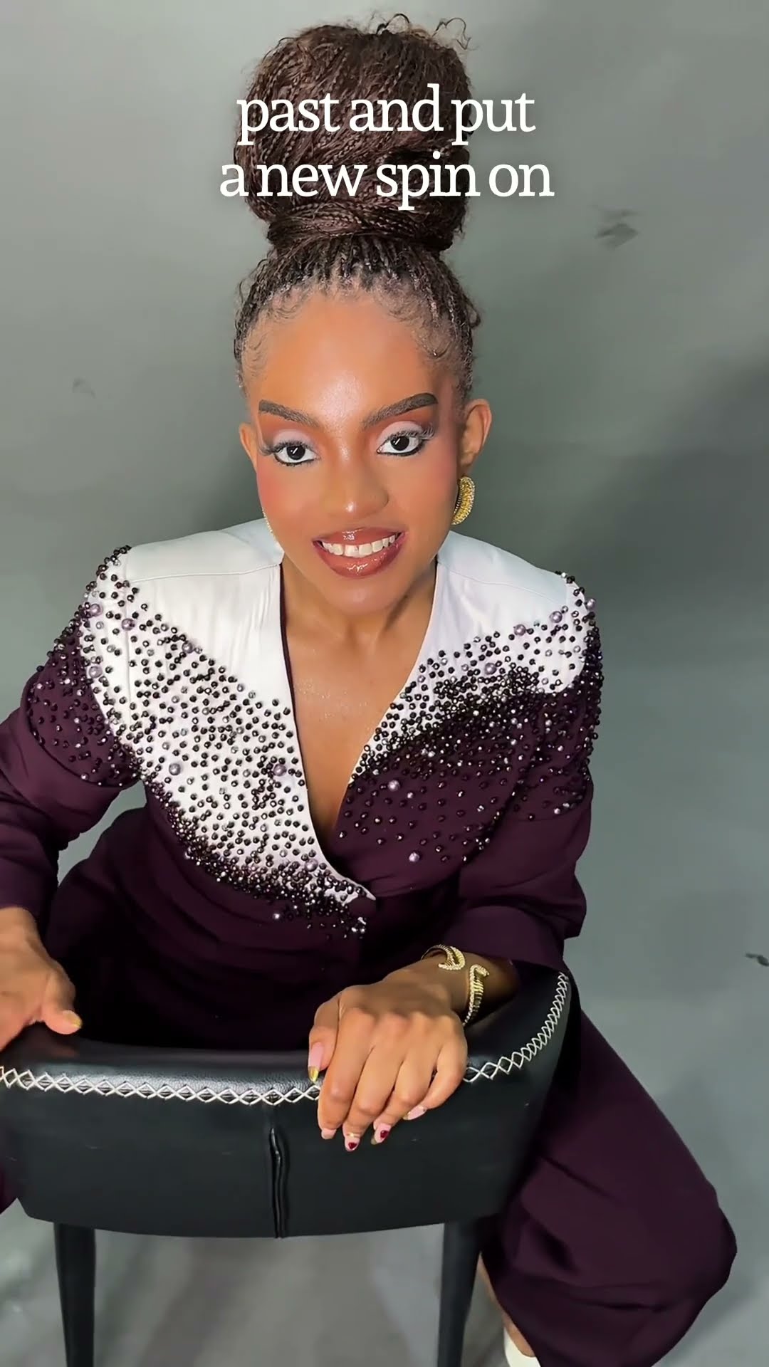 Video still of founder Adaobi Chiamaka Onyekaba in the hand-beaded burgundy Chikamso Suit, ready to speak about the Rose Collection.